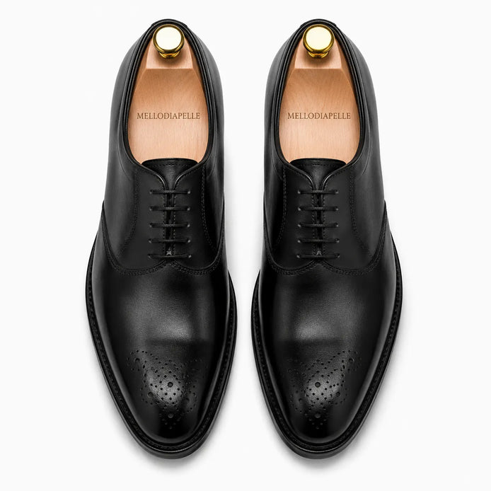 Melodiapelle Meta Wholecut Oxford in nero black leather, pair top-down view, handcrafted in Agra