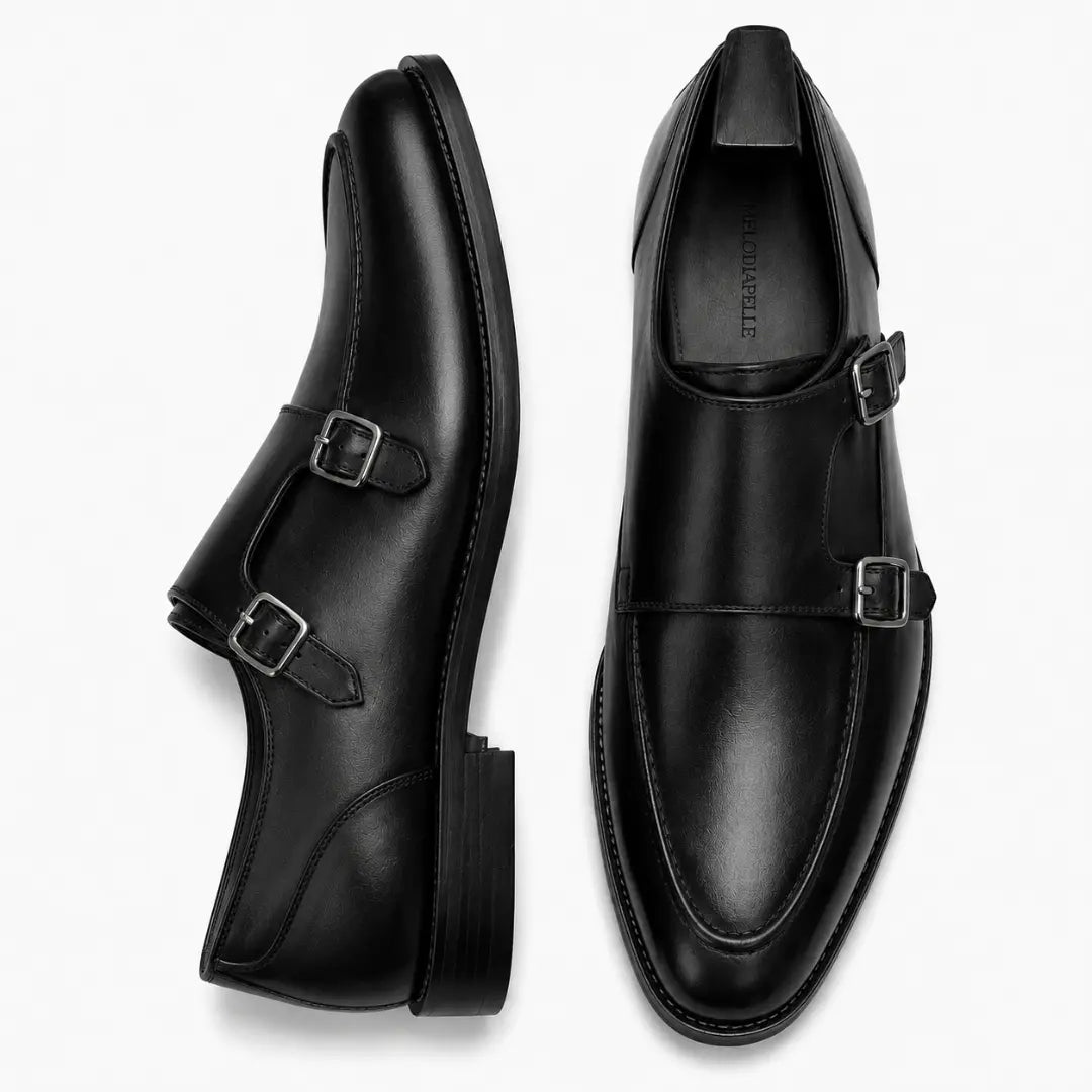 Black leather double monk strap shoe, three-quarter angle showing buckles and heel