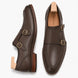 Brown leather double monk strap shoe, three-quarter angle showing buckles and heel