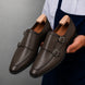 Man holding a pair of Melodiapelle Mexico Double Monk Strap shoes in brown leather, close-up