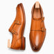 Honey tan burnished leather double monk strap shoe, three-quarter angle showing buckles and heel