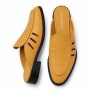 Mustard yellow leather perforated mule, three-quarter angle showing heel and cut-out strap detailing