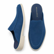 Royal blue suede backless mule, three-quarter angle showing heel and sole detailing