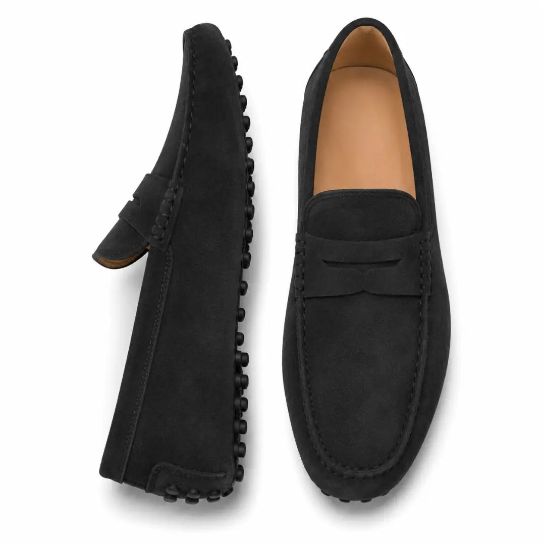 Black suede penny loafer, three-quarter angle showing sole detailing