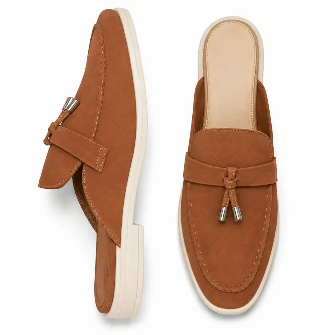 Rust tan suede tassel mule, three-quarter angle showing tassel and sole detailing