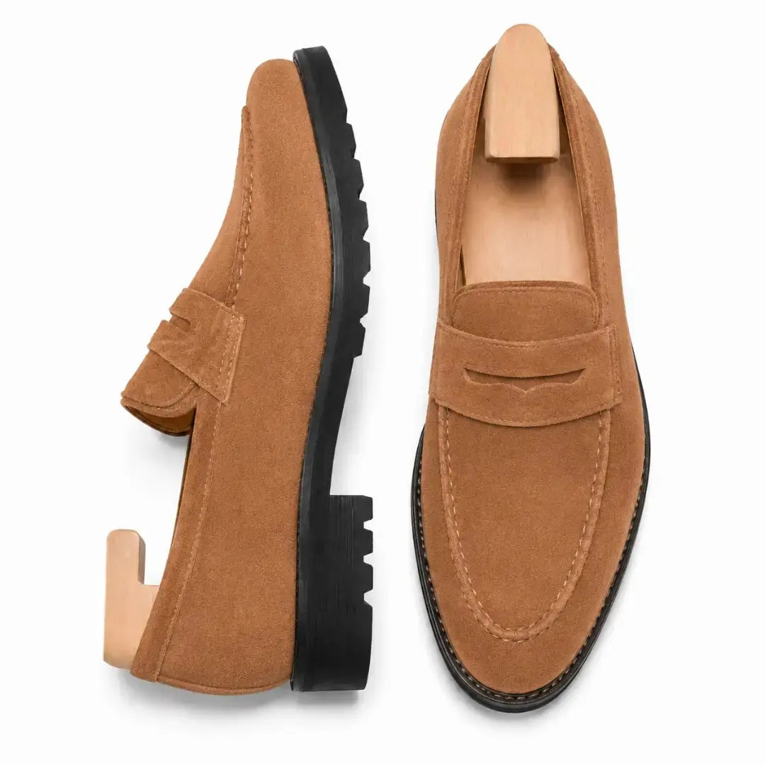 Rust tan suede penny loafer, three-quarter angle showing heel and lug-sole detailing