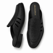 Black embossed leather perforated mule, three-quarter angle showing heel and texture detailing