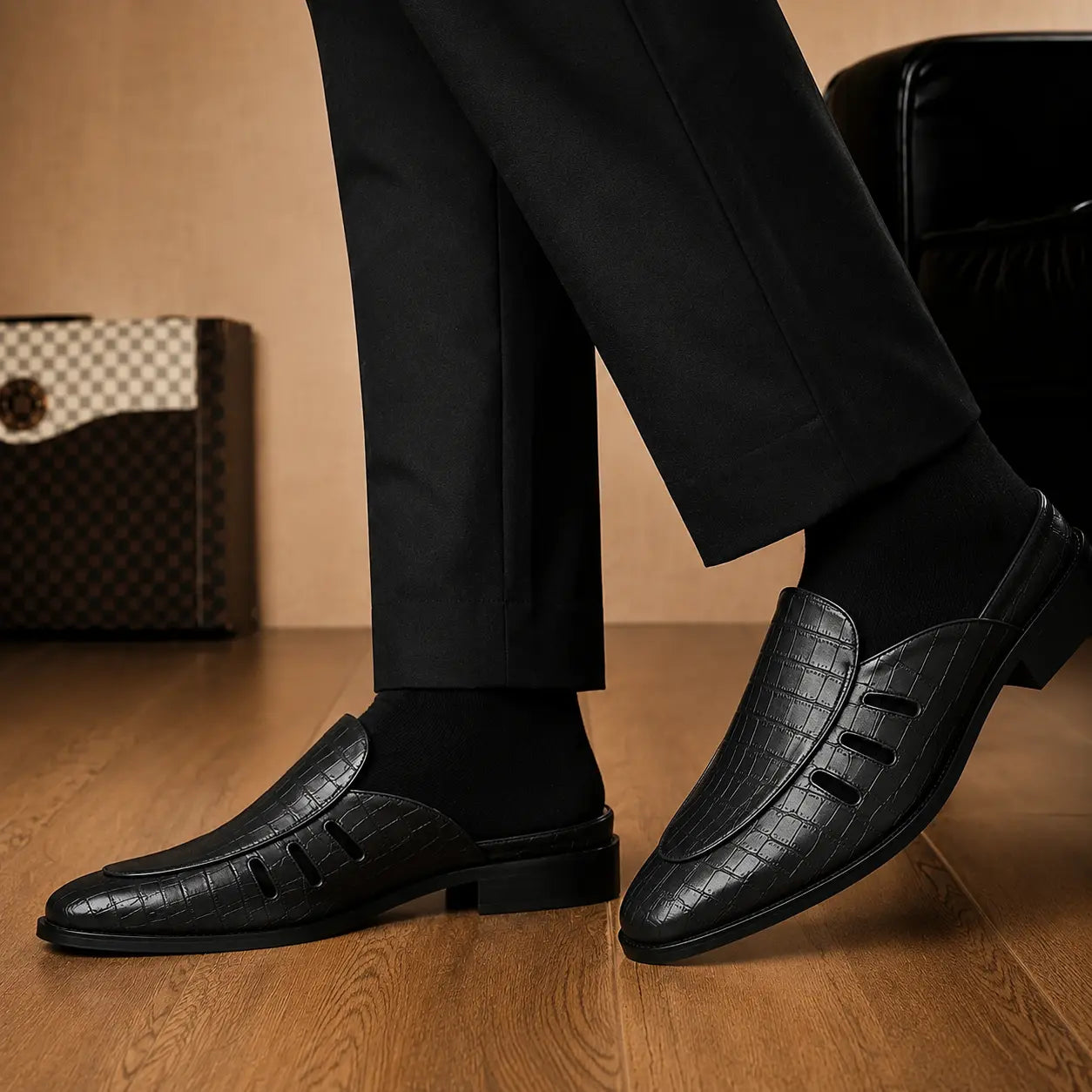 Melodiapelle Milan Mule in black embossed leather worn with formal trousers, on-feet shot