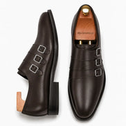 Brown leather triple monk strap loafer, three-quarter angle showing buckles and heel