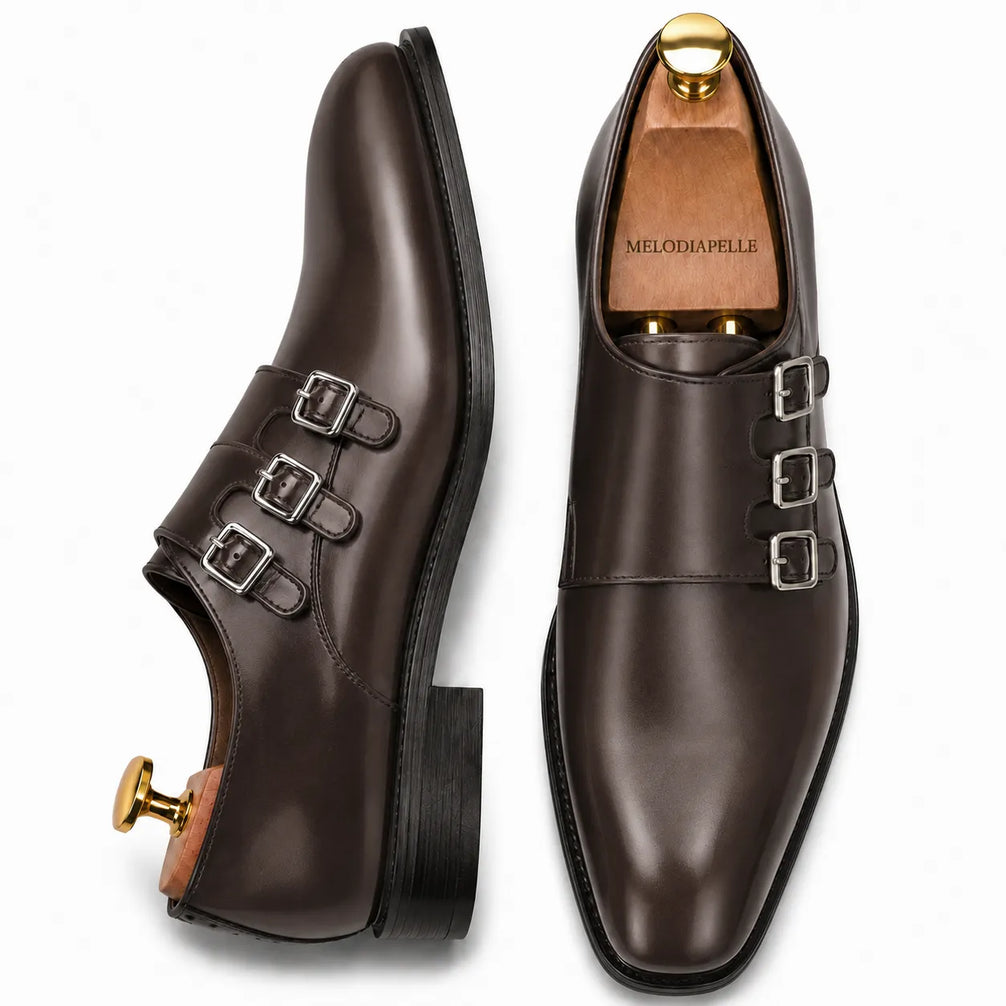 Brown leather triple monk strap loafer, three-quarter angle showing buckles and heel