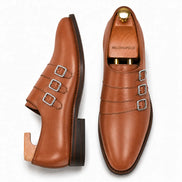 Tan leather triple monk strap loafer, three-quarter angle showing buckles and heel