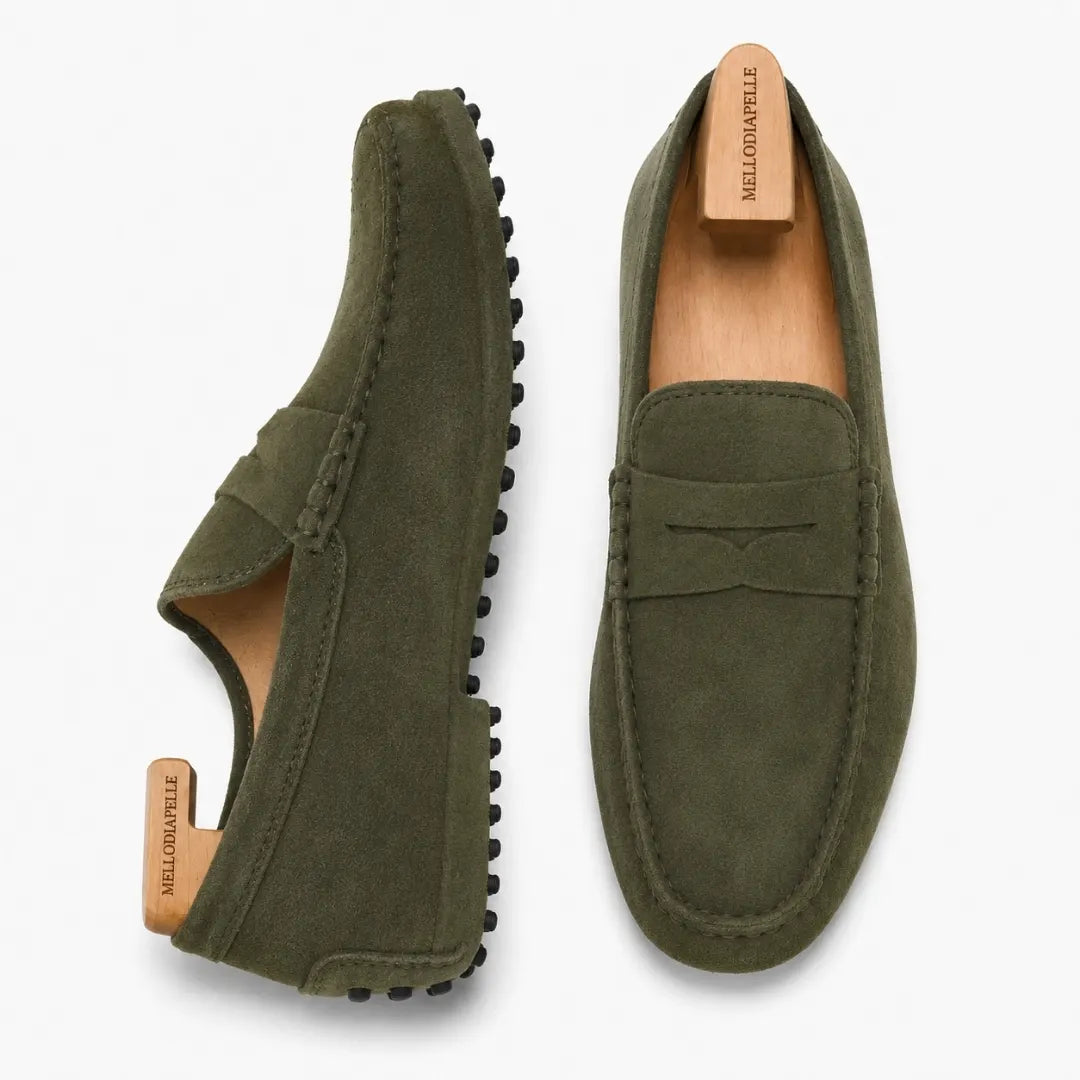 Olive green suede penny loafer, three-quarter angle showing sole detailing