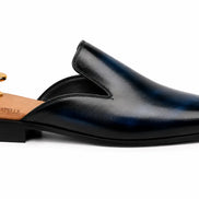 Side profile of the Millburn Mule in navy blue leather on white background