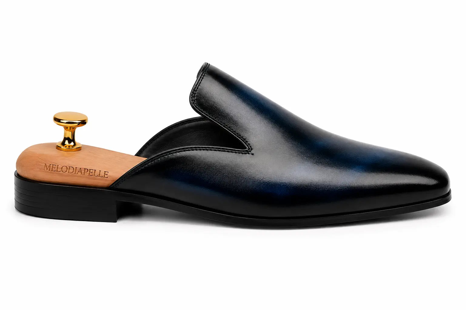 Side profile of the Millburn Mule in navy blue leather on white background