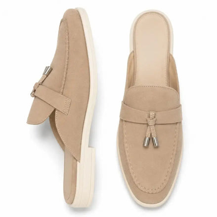 Sand beige suede apron-toe tassel mule, three-quarter angle showing tassel and sole detailing