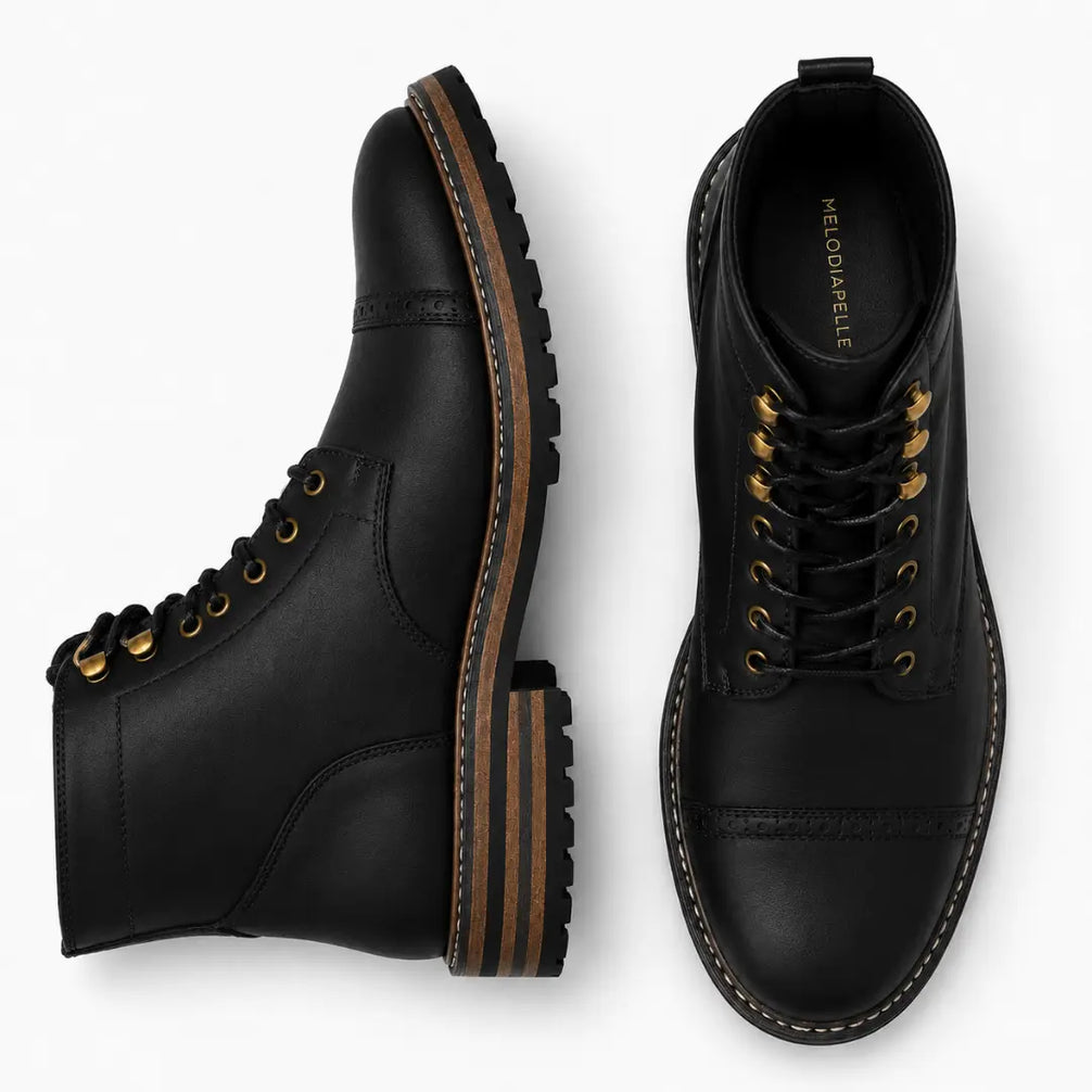 Black leather heritage boot, three-quarter angle showing cap-toe and heel detailing