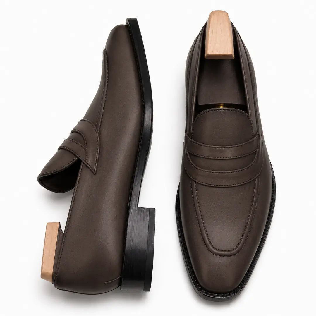 Brown leather dress loafer, three-quarter angle showing band strap and heel