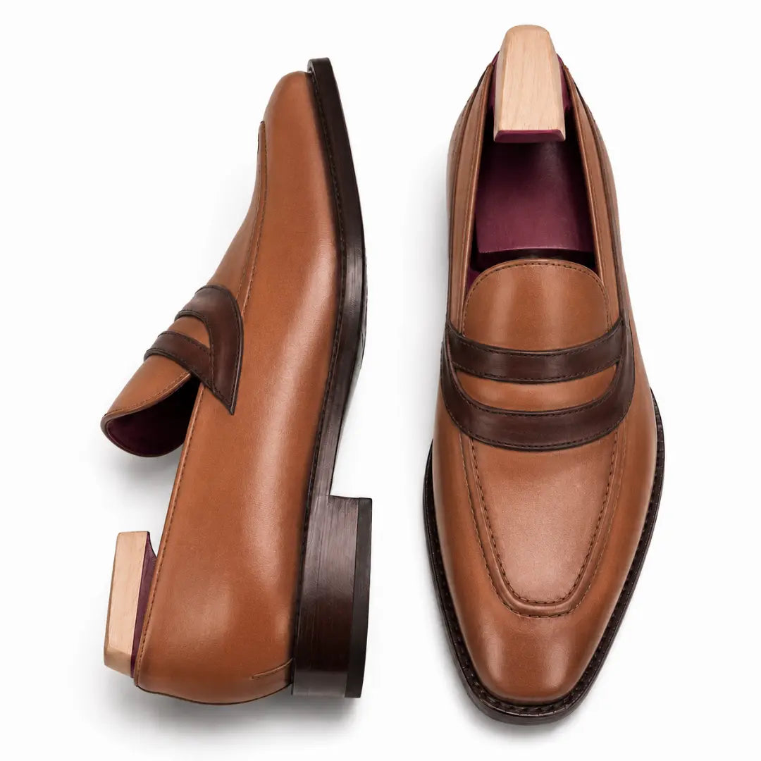 Tan leather dress loafer, three-quarter angle showing band strap and heel