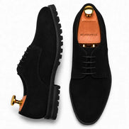 Black suede plain-toe Derby, three-quarter angle showing heel and sole detailing