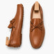 Tan leather driving loafer with bow lace, three-quarter angle showing sole detailing