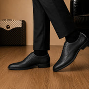 Melodiapelle Missourie Longwing Brogue Derby in black leather worn with formal trousers, on-feet shot