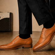 Melodiapelle Missourie Longwing Brogue Derby in natural tan leather worn with formal trousers, on-feet shot