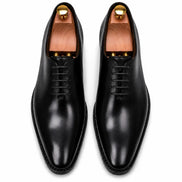 Melodiapelle Modesto Wholecut Oxford in black leather, pair top-down view, handcrafted in Agra