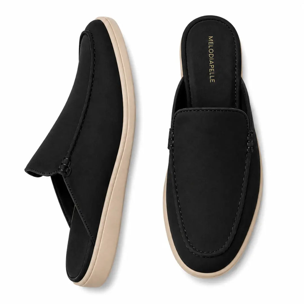 Black suede backless mule slipper, three-quarter angle showing heel and sole detailing