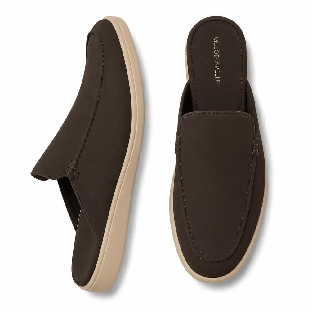 Dark brown suede backless mule slipper, three-quarter angle showing heel and sole detailing