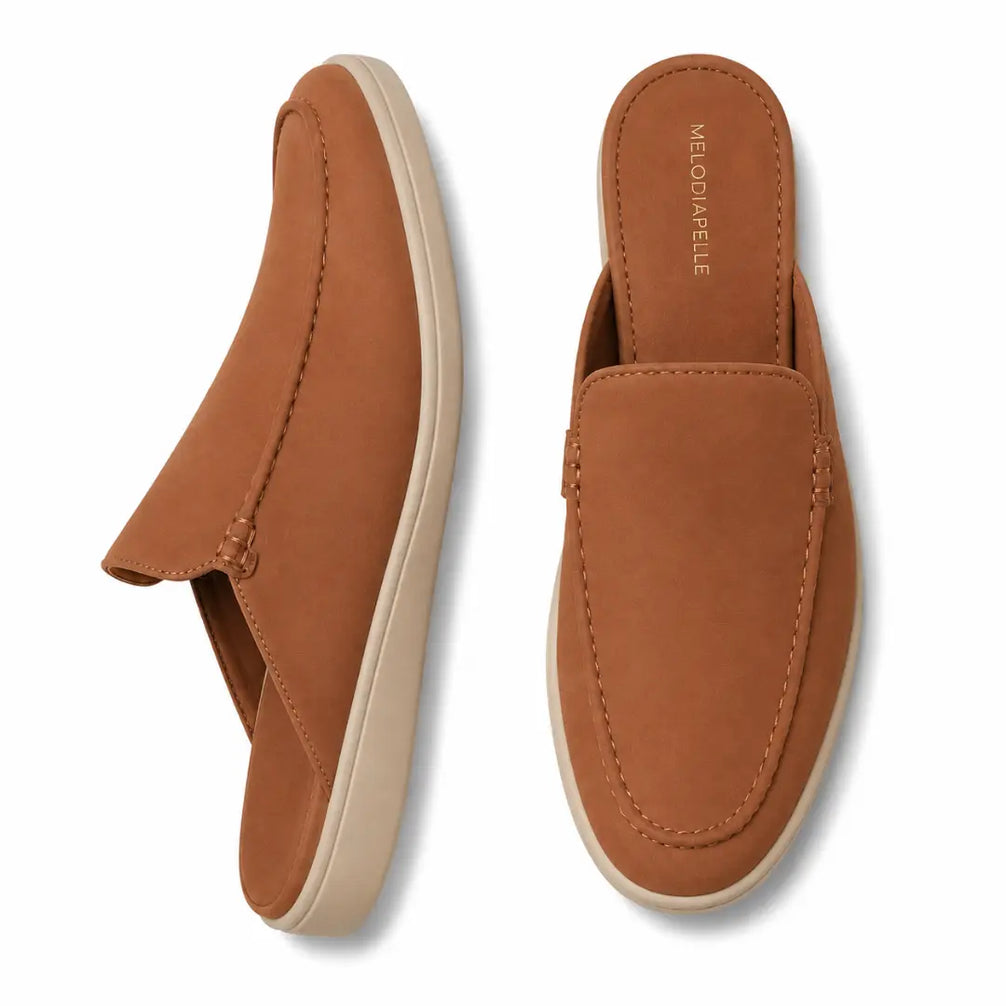 Tan rust suede backless mule slipper, three-quarter angle showing heel and sole detailing