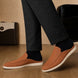 Melodiapelle Mole Mule in tan rust suede worn with trousers, on-feet shot