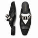 Black and white woven leather mule, three-quarter angle showing buckle strap and heel detailing