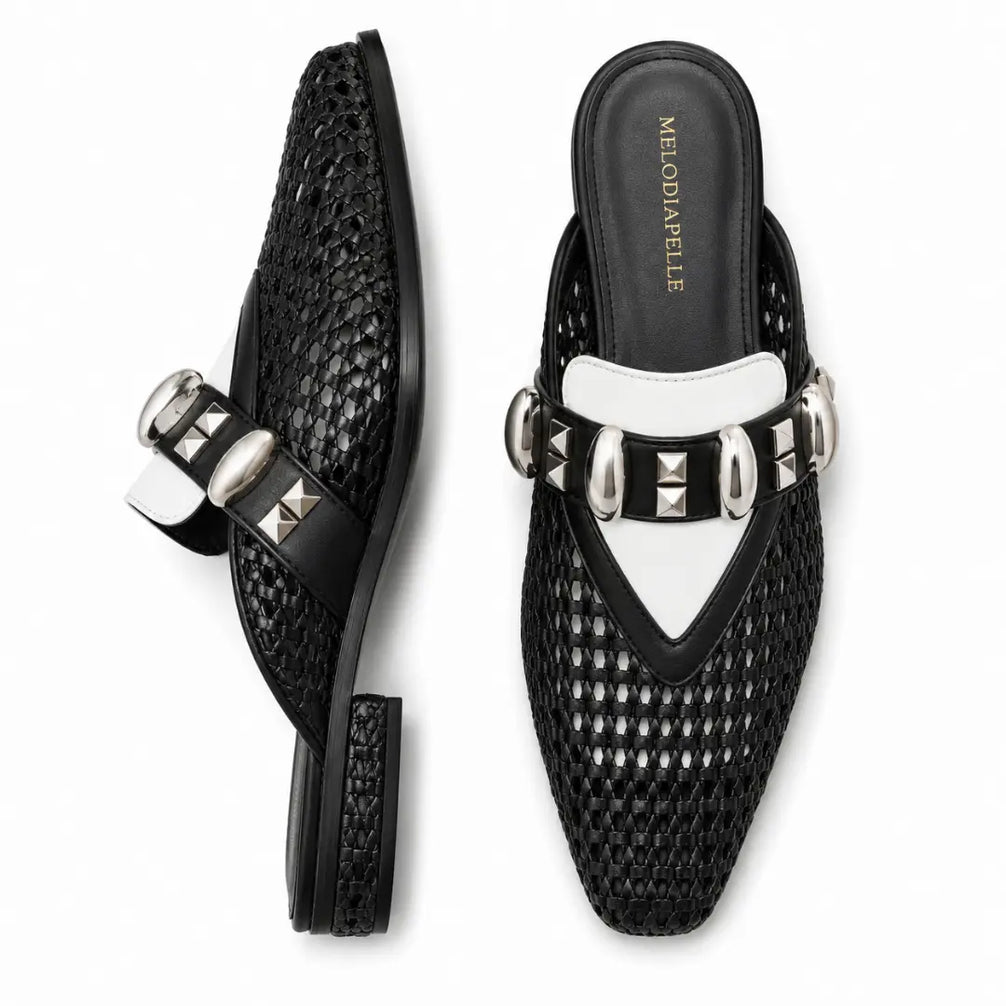 Black and white woven leather mule, three-quarter angle showing buckle strap and heel detailing