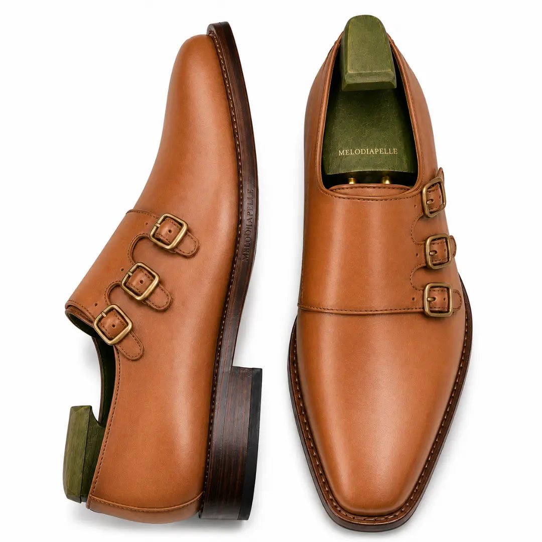 Tan leather double monk strap shoe, three-quarter angle showing buckles and heel