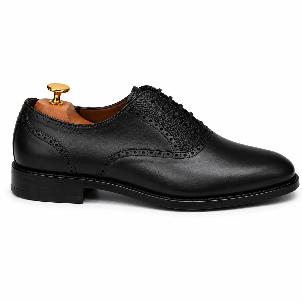 Side profile of the Montserrat Two-Tone Saddle Oxford in black leather on white background
