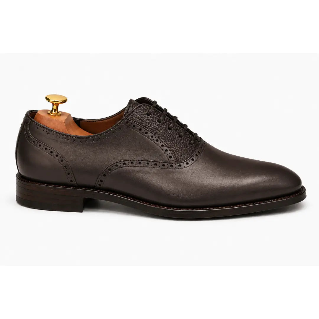 Side profile of the Montserrat Two-Tone Saddle Oxford in brown leather on white background
