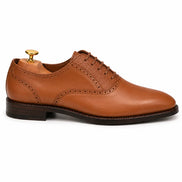 Side profile of the Montserrat Two-Tone Saddle Oxford in tan leather on white background