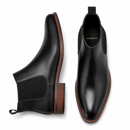 Black suede Chelsea boot, three-quarter angle showing heel and elastic side panel