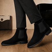 Melodiapelle Moorgate Suede Chelsea Boot in jet black suede worn with formal trousers, on-feet shot
