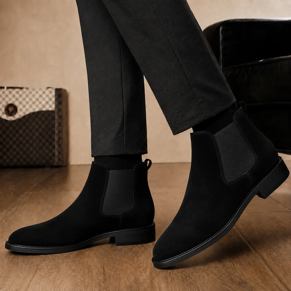 Melodiapelle Moorgate Suede Chelsea Boot in jet black suede worn with formal trousers, on-feet shot