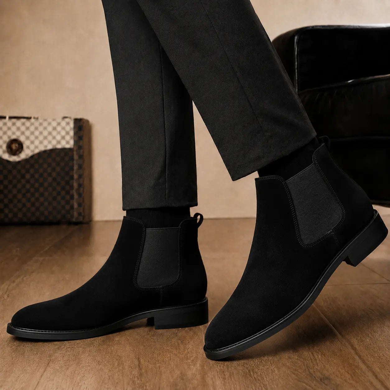 Melodiapelle Moorgate Suede Chelsea Boot in jet black suede worn with formal trousers, on-feet shot
