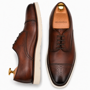 Dark chocolate leather cap-toe Derby, three-quarter angle showing heel and brogue detailing