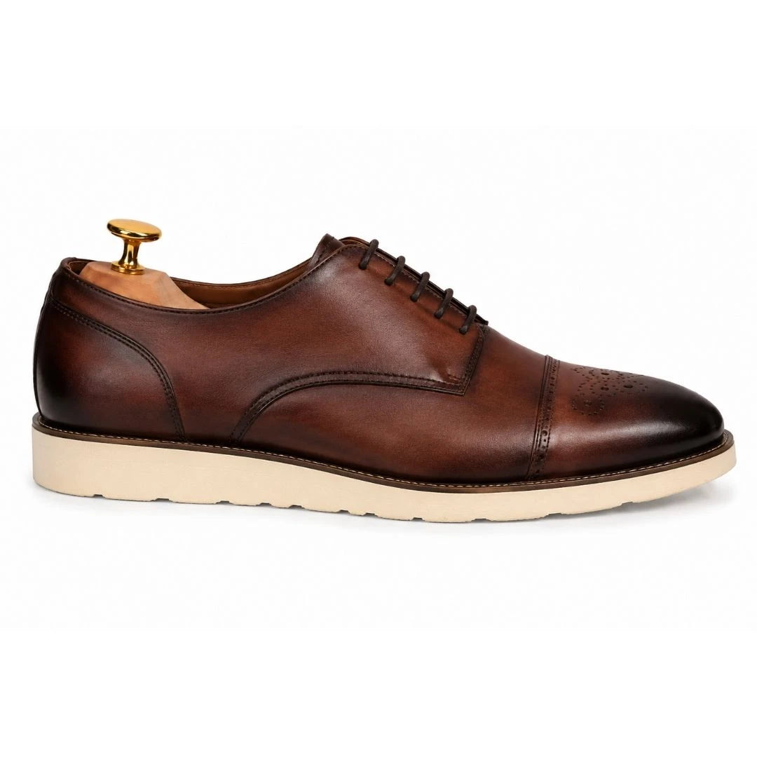 Side profile of the Moorland Cap-Toe Derby in dark chocolate leather on white background
