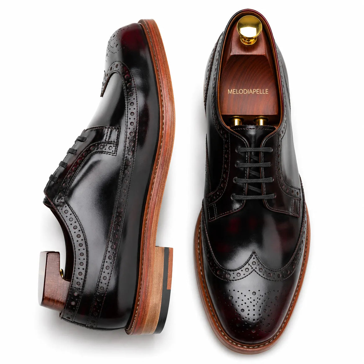Oxblood brown leather wingtip brogue Derby, three-quarter angle showing heel and brogue detailing