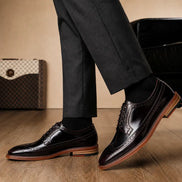 Melodiapelle Morano Wingtip Brogue Derby in oxblood brown leather worn with formal trousers, on-feet shot