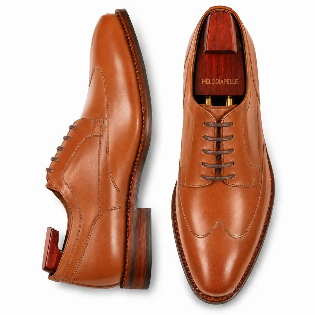 Tan leather wingtip brogue Derby, three-quarter angle showing heel and brogue detailing