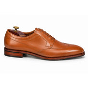 Side profile of the Morano Wingtip Brogue Derby in tan leather on white background