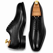 Black leather wholecut Oxford, three-quarter angle showing seamless upper and heel