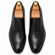 Melodiapelle Mordecai Script Wholecut Oxford in black leather, pair top-down view, handcrafted in Agra