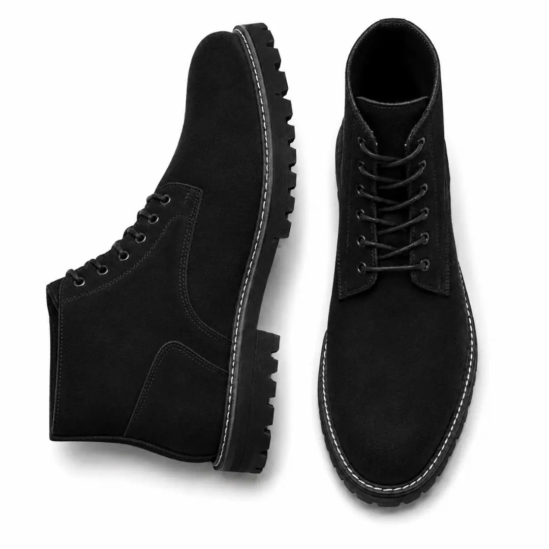 Black suede combat boot, three-quarter angle showing heel and sole detailing